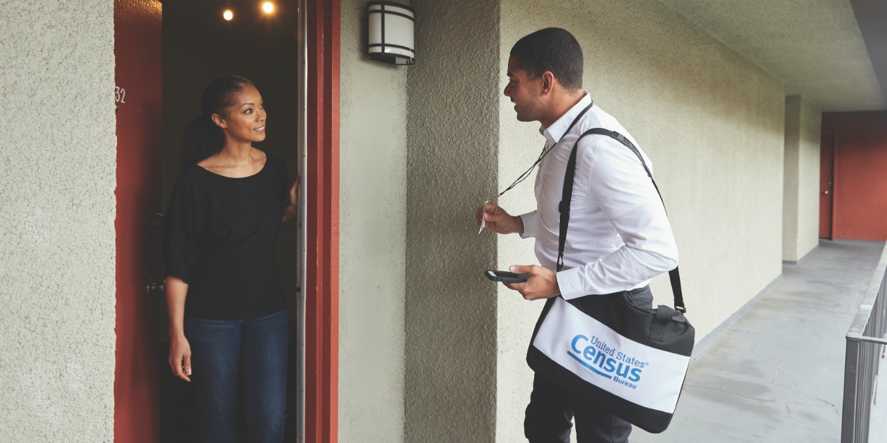 Census worker talking with woman