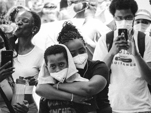 Black and white photo of youth and mother at a protest