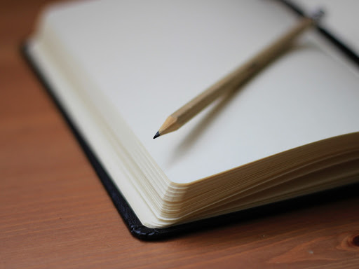 Open notebook with pencil