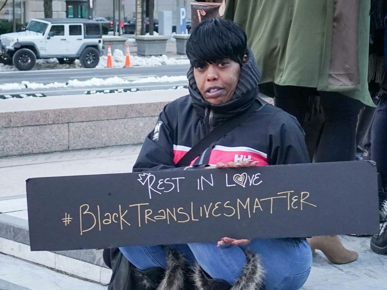 Person holding a #BlackTransLivesMatter sign