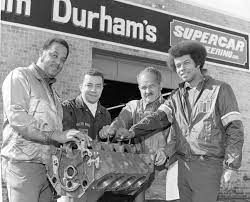 Racers with pictured with racecar engine