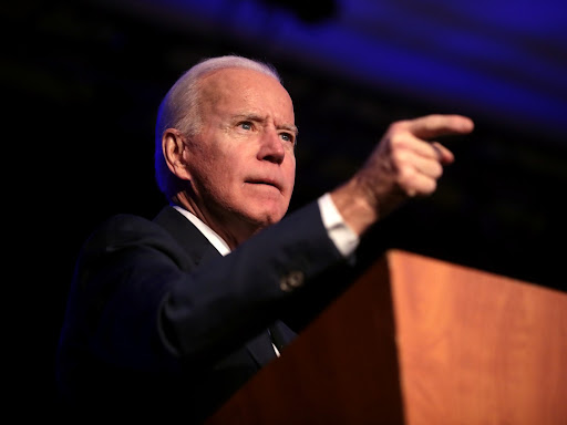 joe biden pointing from a podium