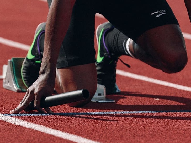 Track runner on starting block
