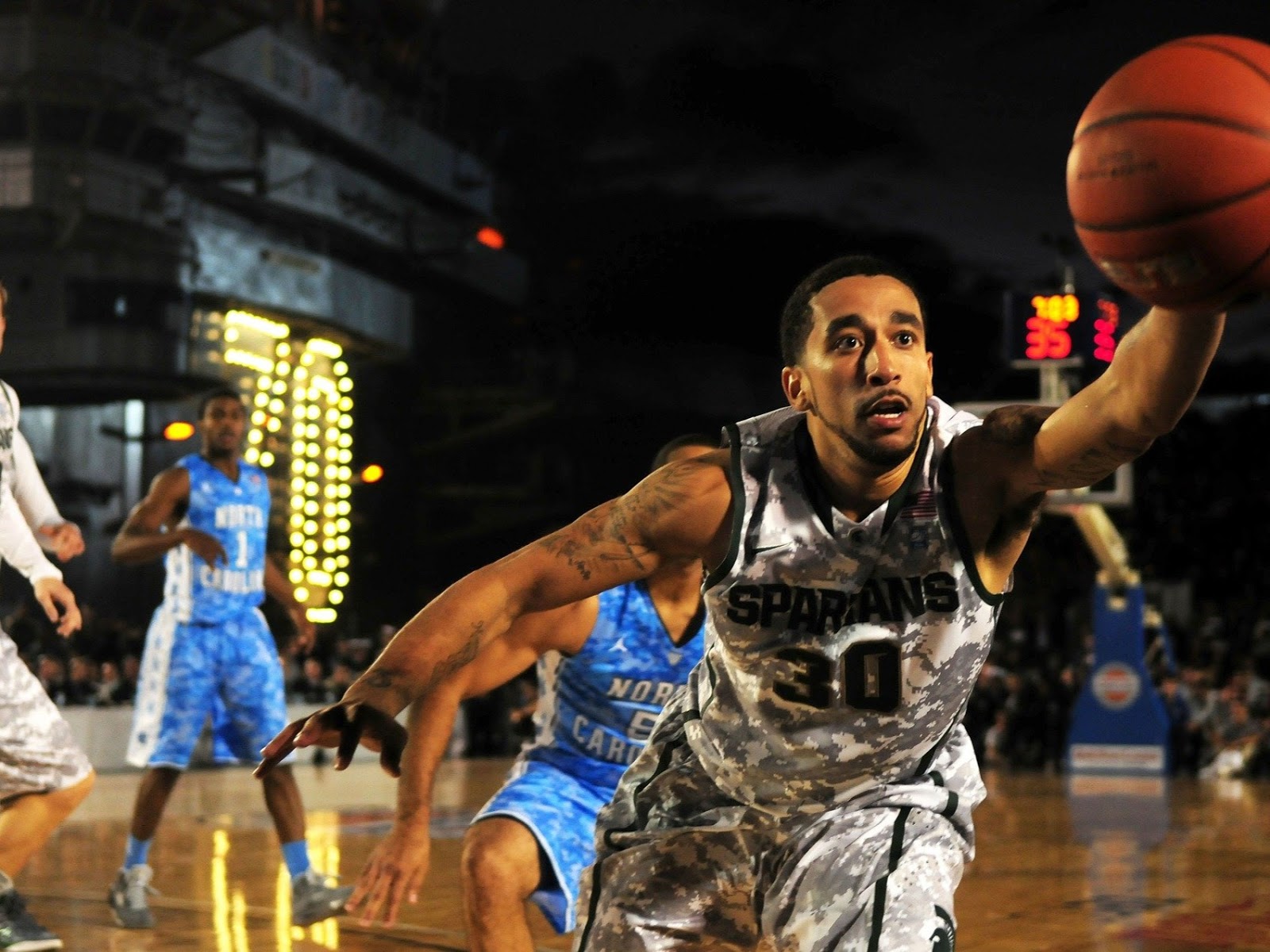 basketball player reaching for ball