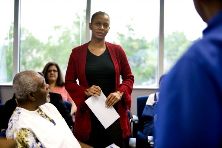 Woman posing question to group
