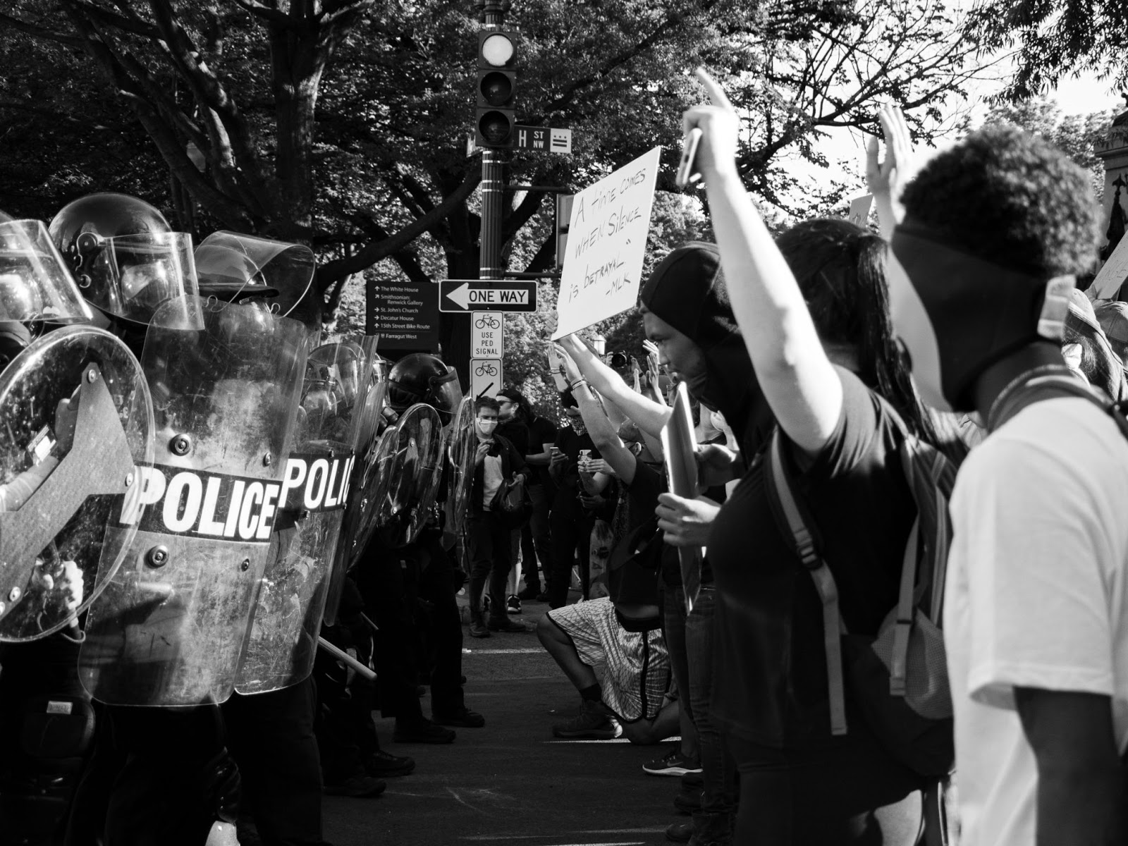 Police in riot gear in front of demonstrators