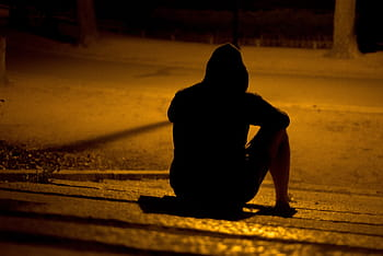 Shadow figure sitting alone
