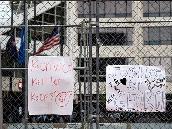 A Justice For George sign outside the Hennepin County Government Center