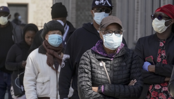 People in a line with face masks