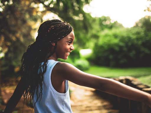 young black girl smiling outside 