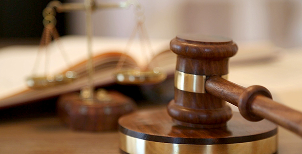 Judge banging a gavel in a courtroom