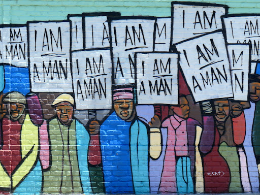  protestors holding up signs that say i am a man