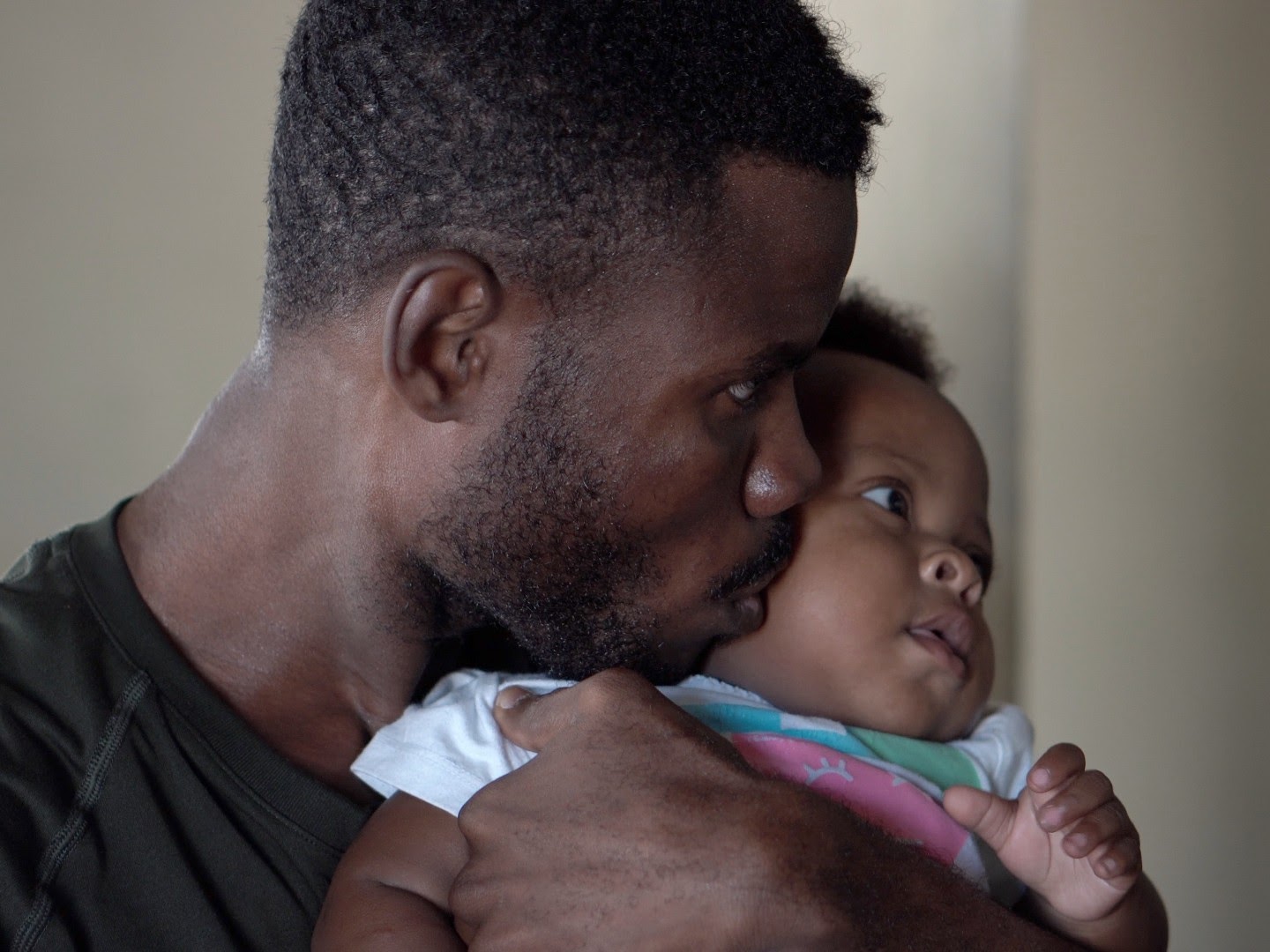 Man kissing baby