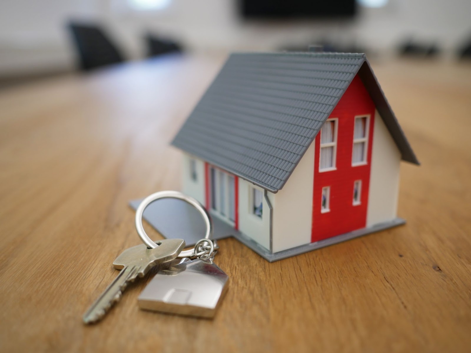 keychain in front of small model home