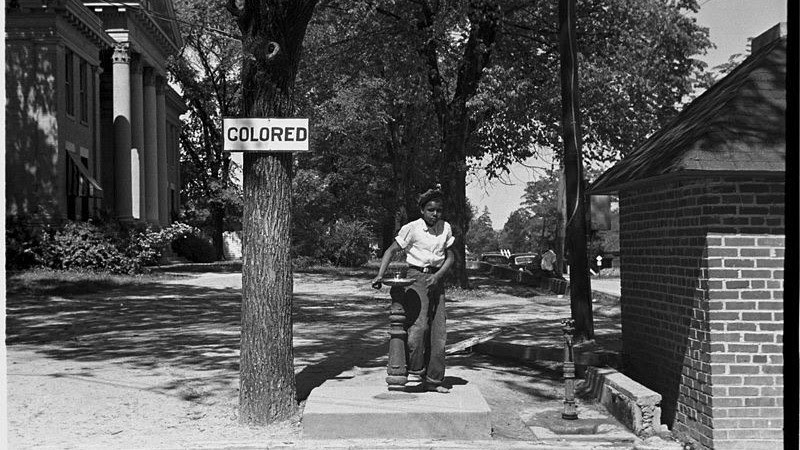 Young girls at Jim Crow water fountain