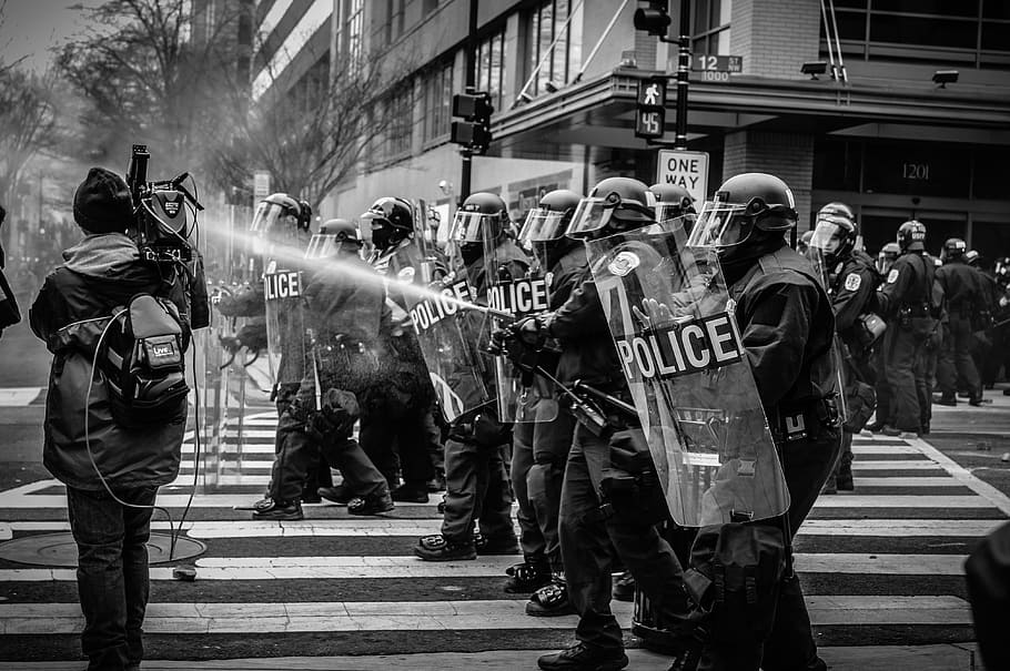 Police in riot gear spraying water