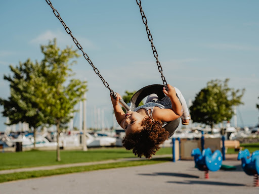 little girl in a tire swing