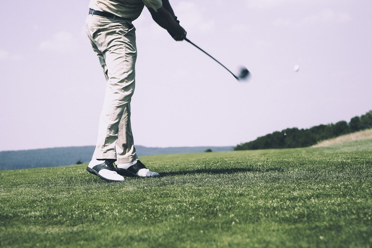 Person swinging golf club