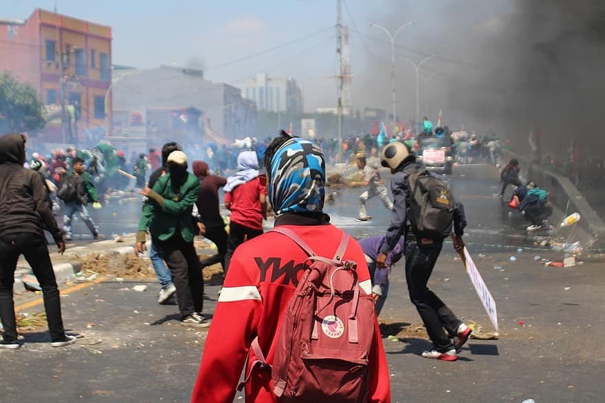 Crowd dispersing in smoke
