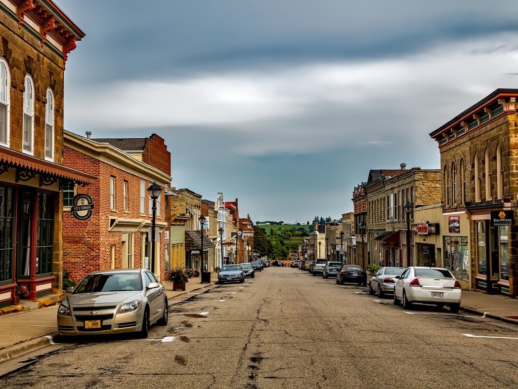 cars parked along a street with businesses