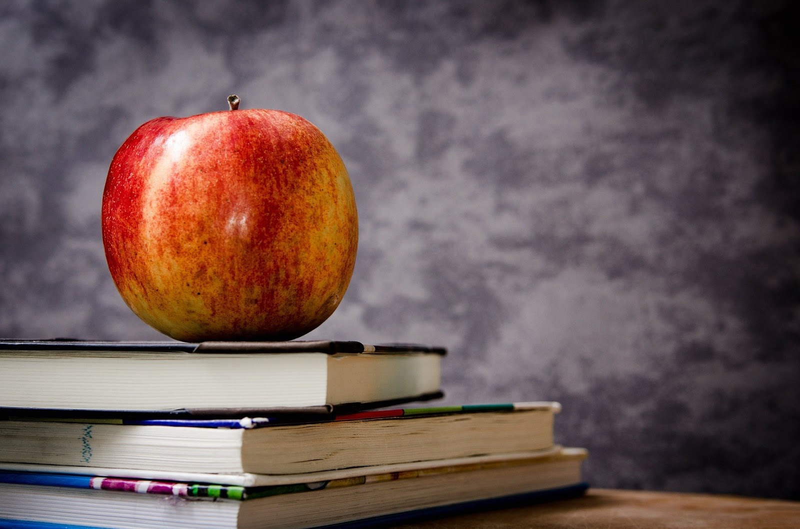 An apple on the top of books