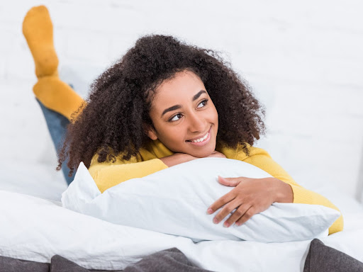 black woman laying on pillow