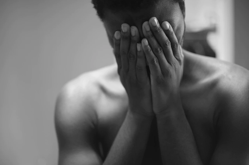 person covering face with hands