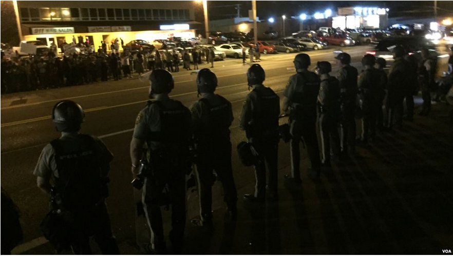 Police lined up along a street
