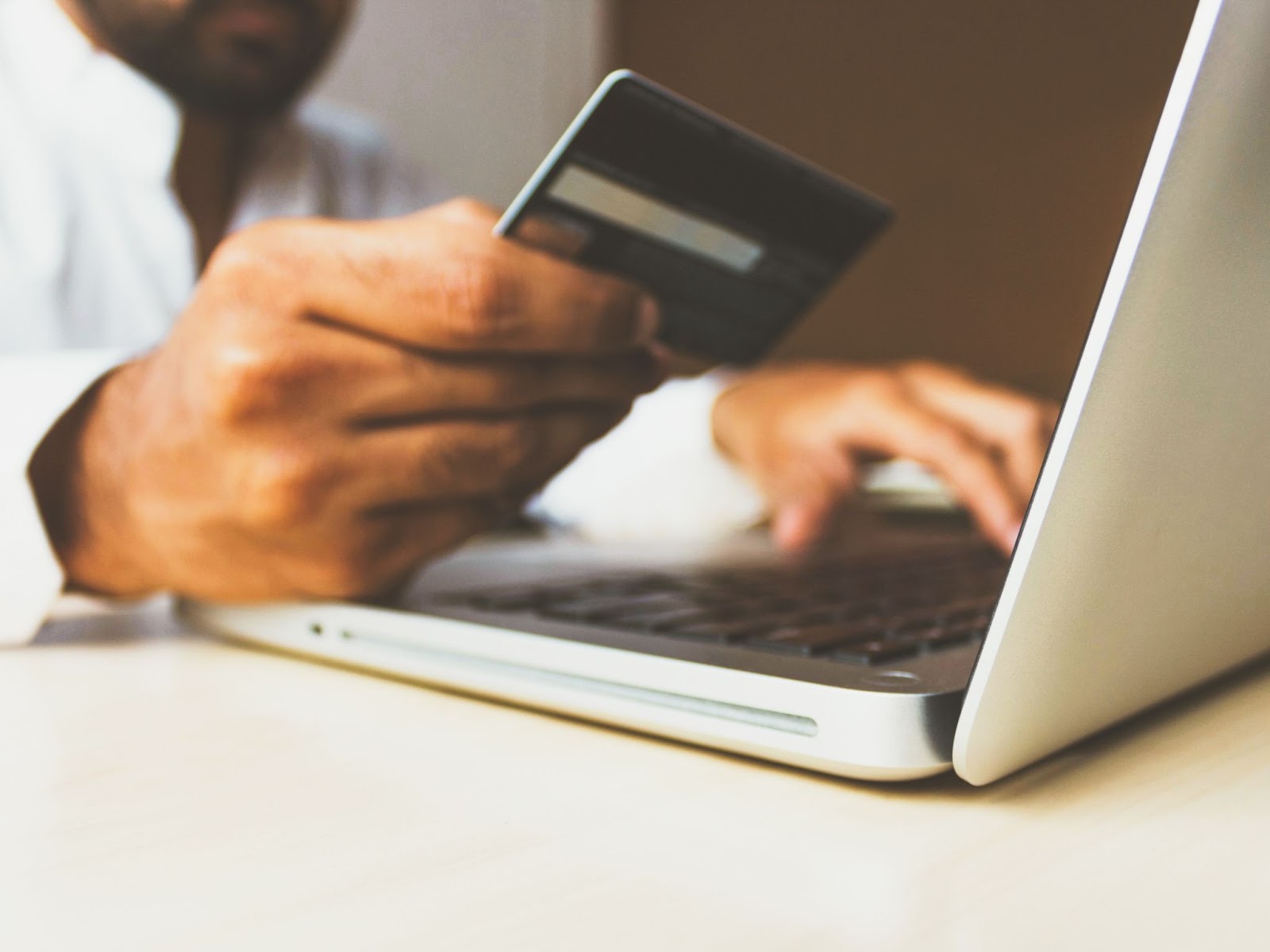 Man with credit card in front 