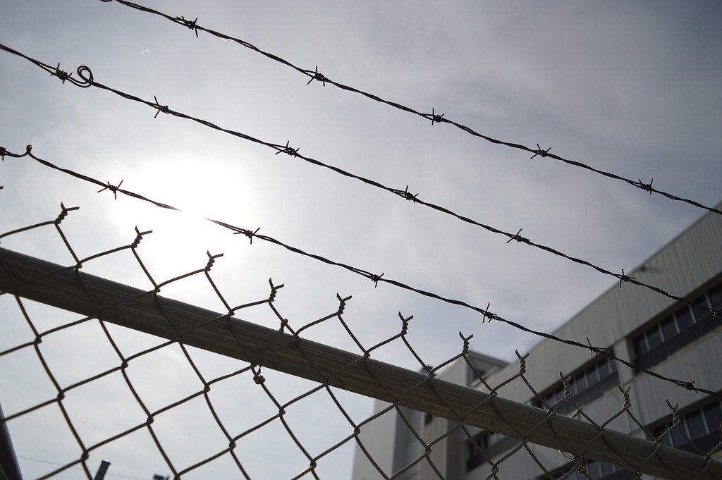 Barb wire fence in front of jail