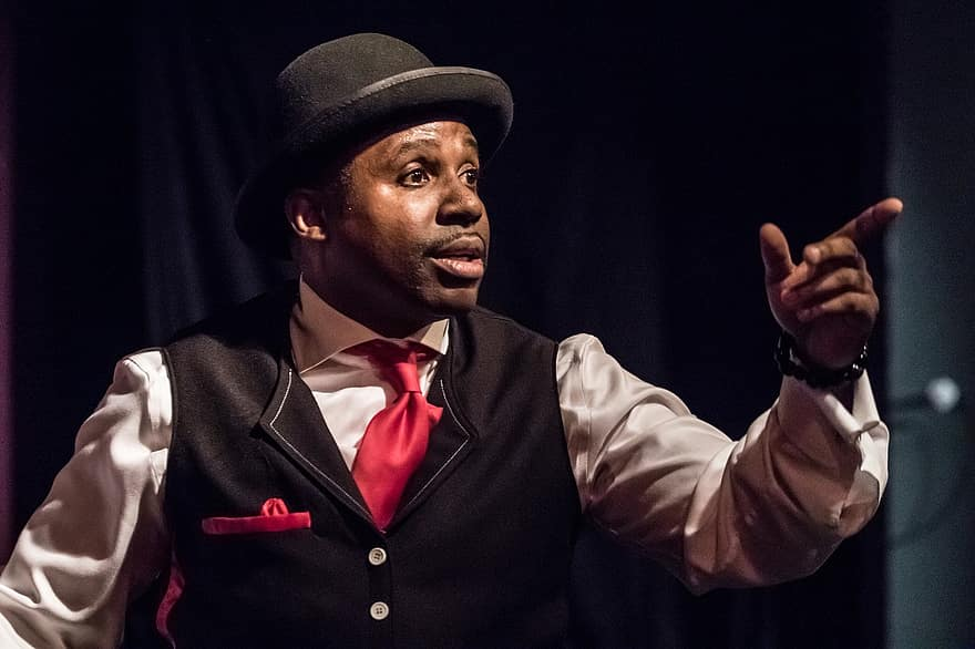 An entertainer pointing at audience
