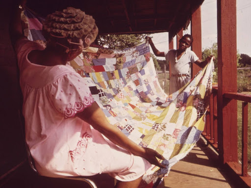 Woman folding quilt
