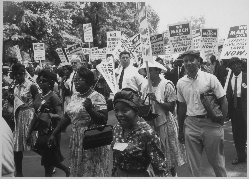 Demonstrators walking with signs