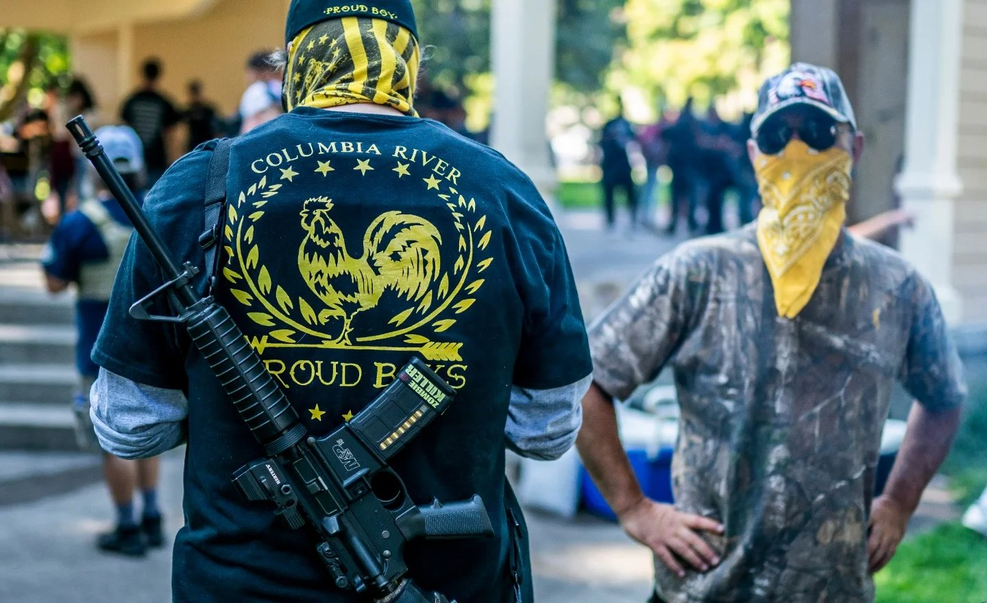 Man with assault rifle hanging on back