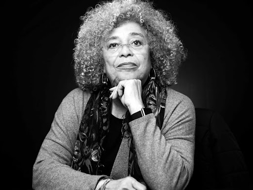 black and white photo of angela with fist resting underneath her chin