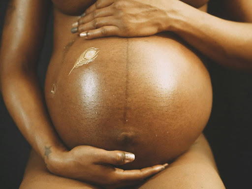 a close up of a pregnant person's belly