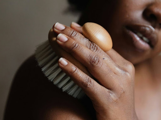 close up of a person holding a brush 
