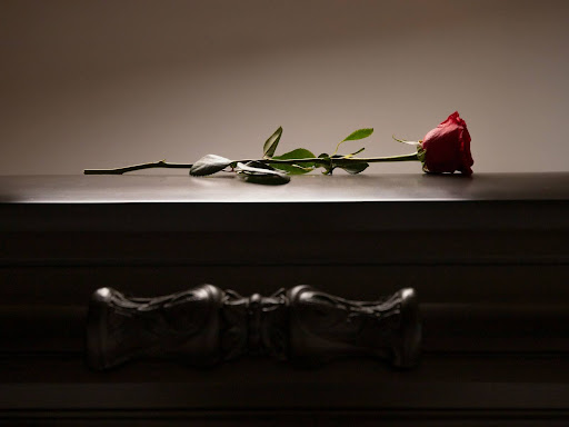 a single rose sitting on top of a table