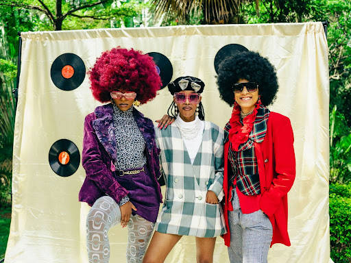 a group of people three people standing next to each other