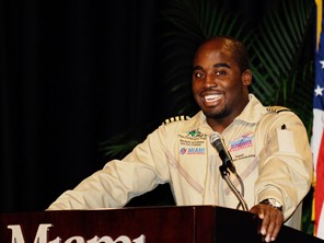 barrington speaking at a podium smiling