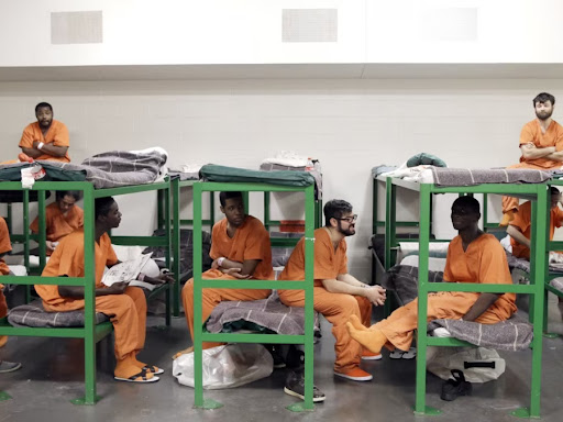 group of prisoners sitting on the bed
