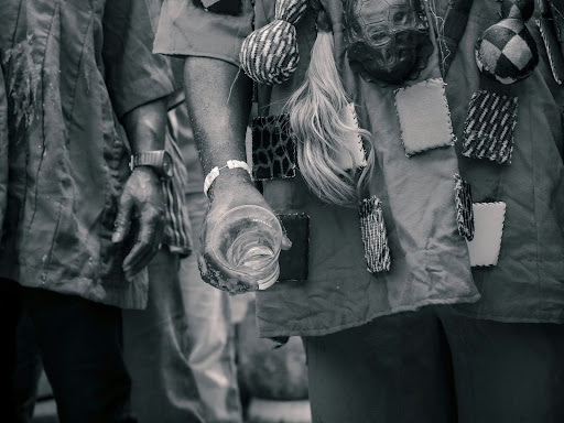 grayscale photo of people gathered and a person pouring out a drink