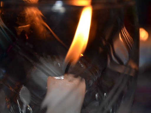 white candle on black surface