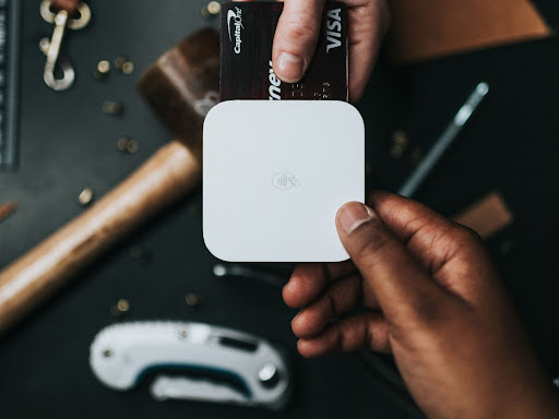 a person inserting their card into a card reader to pay 