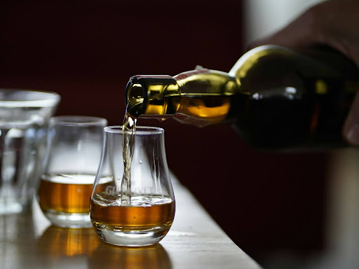 person pouring drinks