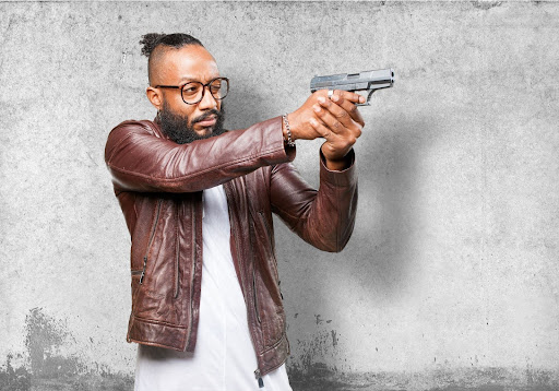 man pointing with gun