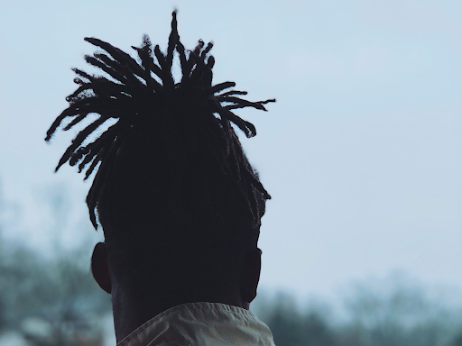 black person with locs in a ponytail