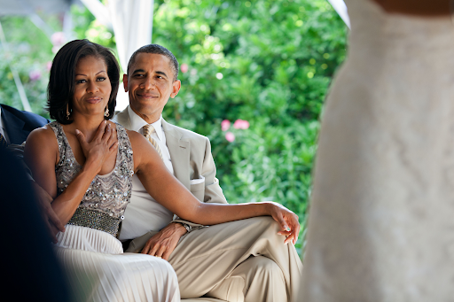 president obama and michelle obama watching a wedding