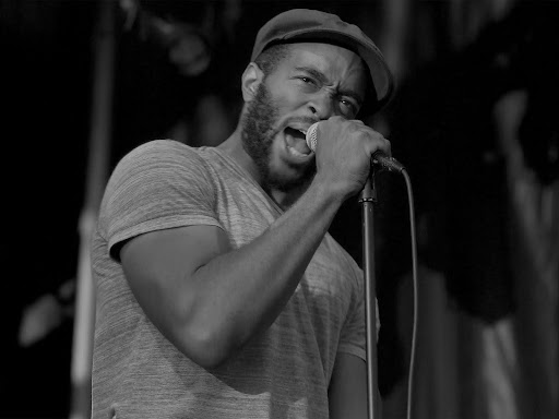 grayscale photography of singing man