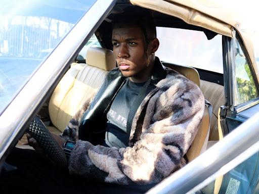 black man sitting in a car 